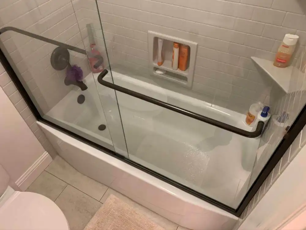 inside of a shower tub with sliding glass door