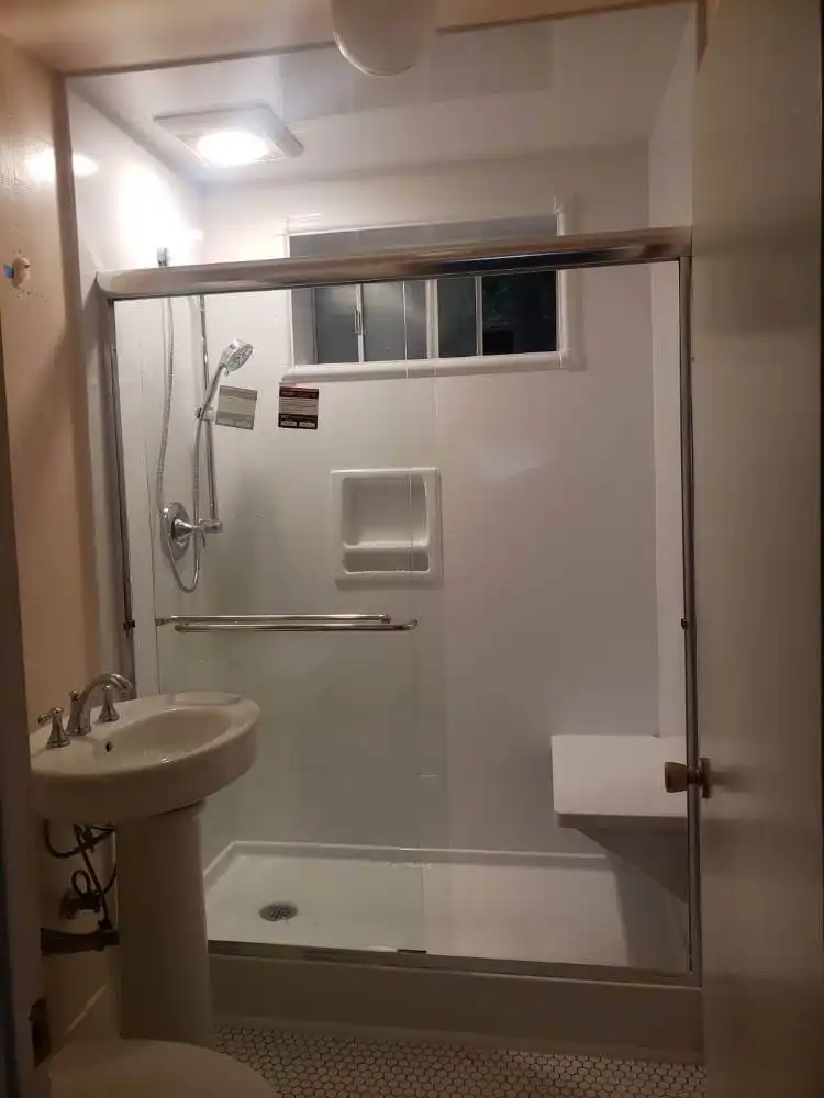 shower in bathroom with shower seat and detachable shower head