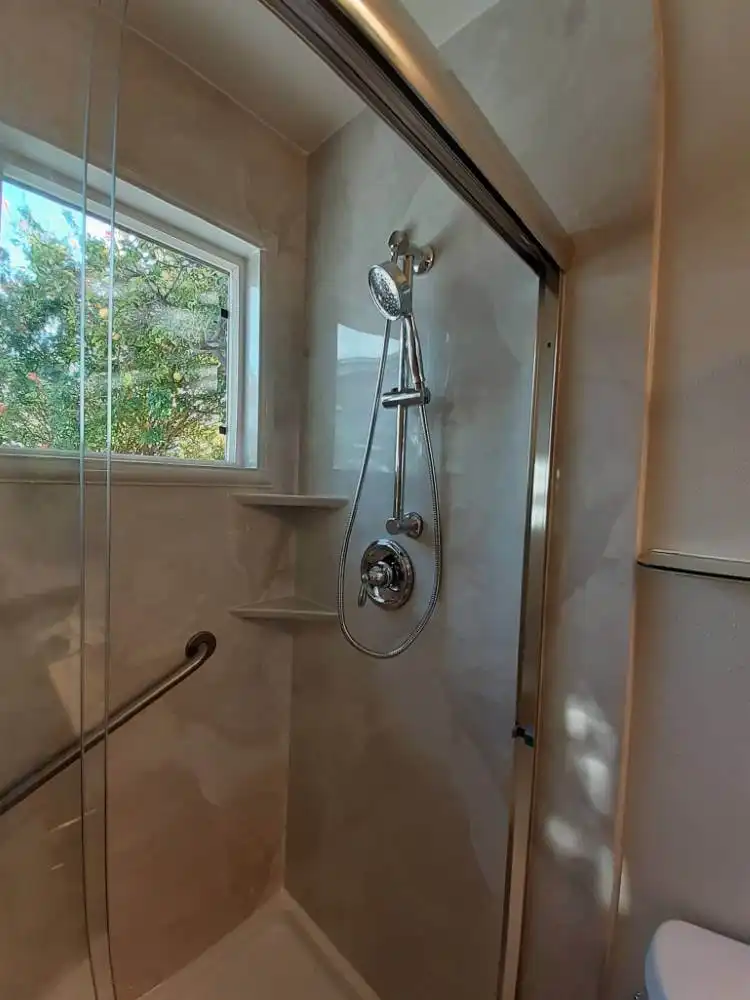 shower with sliding glass door and detachable shower head