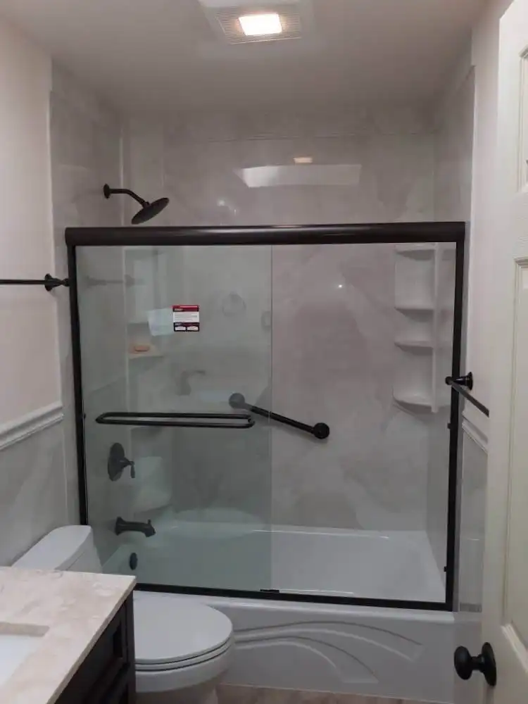 sliding glass shower door with black accents