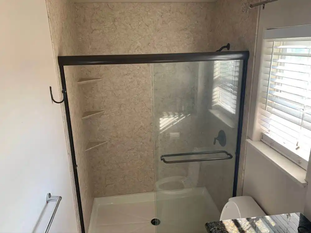 sliding glass shower enclosure with black accents
