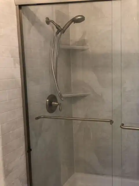 shower with glass sliding door and metal detachable shower head